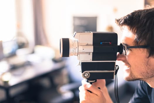 Filmmaker is doing a movie, vintage old movie camera