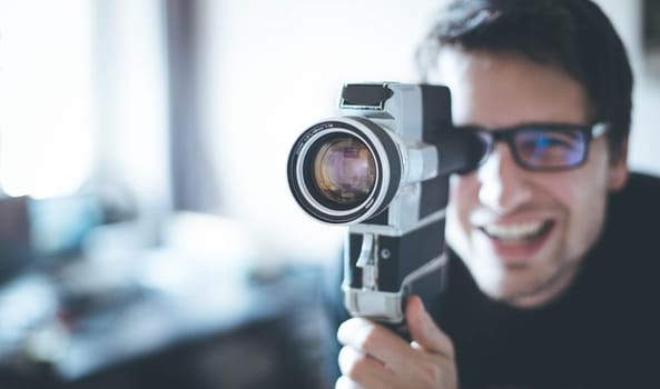 Filmmaker is doing a movie, vintage old movie camera