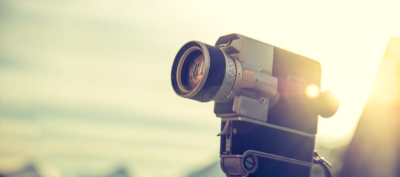 Vintage old movie camera, outdoor, sunset