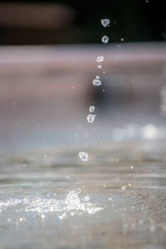 Fresh water drops falling into a well, summer time