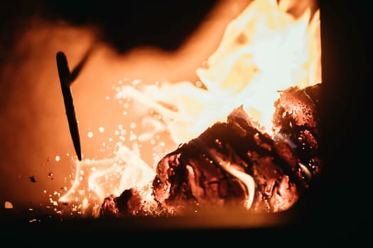 Blaze fire flame in oven, poking stick and sparks