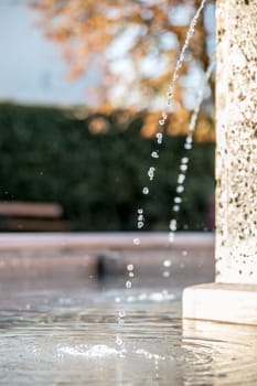 Fresh water drops falling into a well, summer time