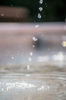 Fresh water drops falling into a well, summer time