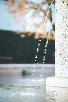 Fresh water drops falling into a well, summer time