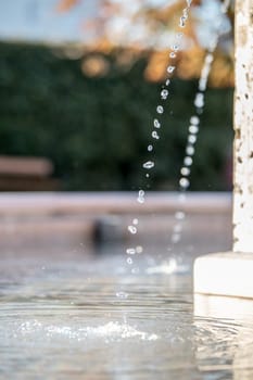 Fresh water drops falling into a well, summer time