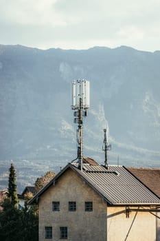 Communication transmitter on the rooftop of a house