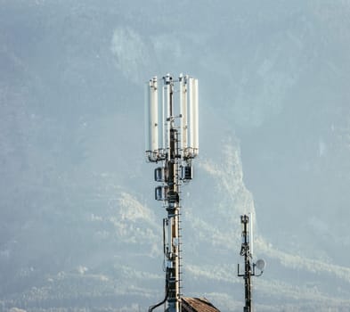 Communication transmitter on the rooftop of a house