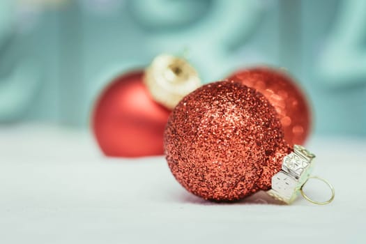 Christmas decoration: Close up of red Christmas baubles, advent calendar in the blurry background