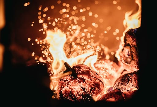 Blaze fire flame in oven, poking stick and sparks