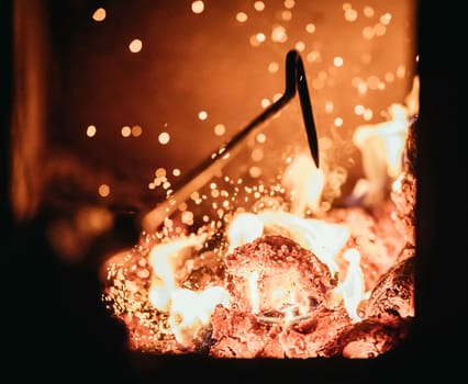 Blaze fire flame in oven, poking stick and sparks