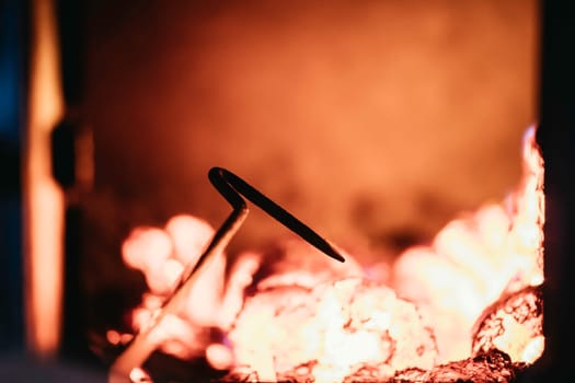 Blaze fire flame in oven, poking stick and sparks