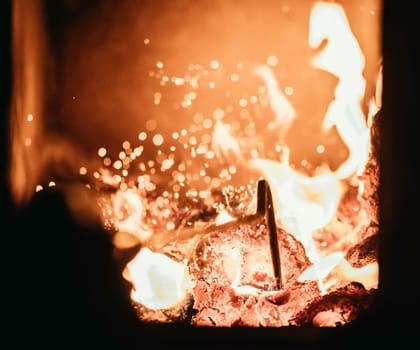 Blaze fire flame in oven, poking stick and sparks