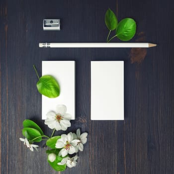 Blank stationery and flowers. Blank business cards, pencil and sharpener. Top view. Flat lay.