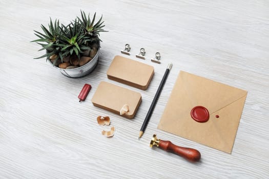 Blank kraft stationery on light wood table background. ID template. Mock-up for branding identity for designers.