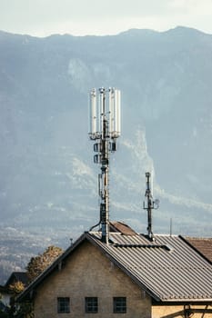 Communication transmitter on the rooftop of a house