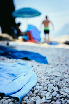 Bathing towel on the beach  other people in blurry background