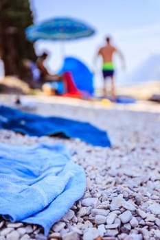 Bathing towel on the beach  other people in blurry background