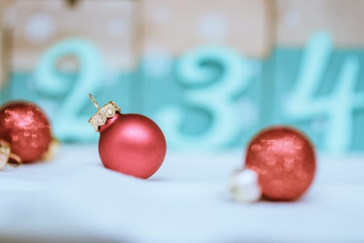 Christmas decoration: Close up of red Christmas baubles, advent calendar in the blurry background