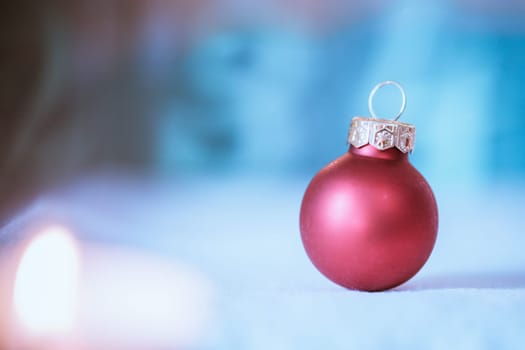 Christmas decoration: Close up of red Christmas baubles, advent calendar in the blurry background