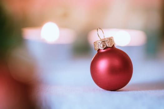 Christmas decoration: Close up of red Christmas baubles, advent calendar in the blurry background