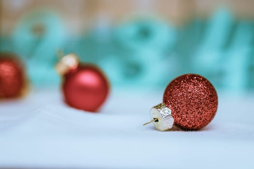 Christmas decoration: Close up of red Christmas baubles, advent calendar in the blurry background