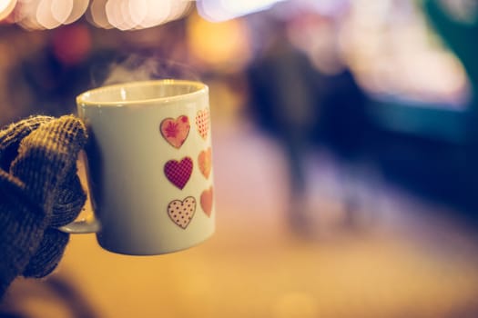 Enjoying Christmas time on the Christmas market. Close up of a cup of mulled wine.