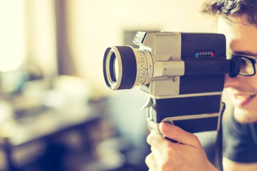 Filmmaker is doing a movie, vintage old movie camera