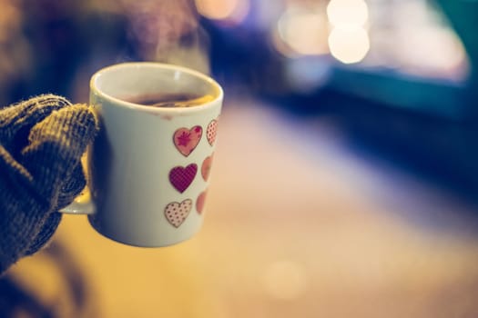 Enjoying Christmas time on the Christmas market. Close up of a cup of mulled wine.