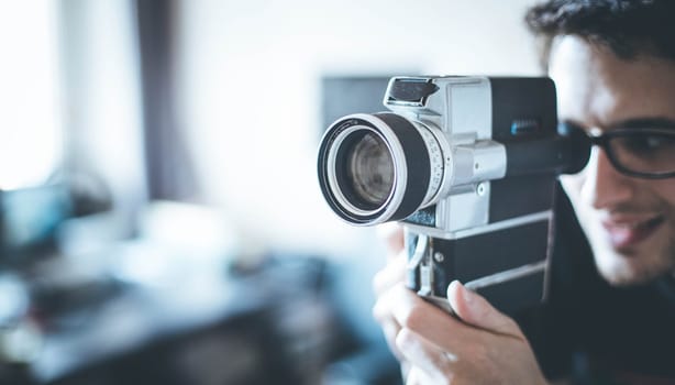 Filmmaker is doing a movie, vintage old movie camera