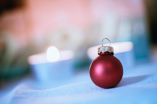 Christmas decoration: Close up of red Christmas baubles, advent calendar in the blurry background