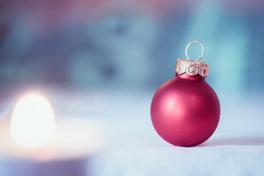 Christmas decoration: Close up of red Christmas baubles, advent calendar in the blurry background