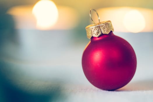 Christmas decoration: Close up of red Christmas baubles, advent calendar in the blurry background