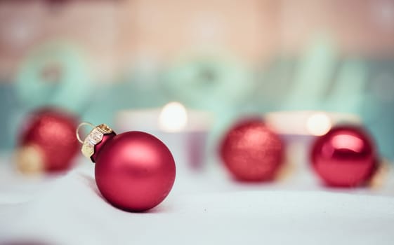 Christmas decoration: Close up of red Christmas baubles, advent calendar in the blurry background