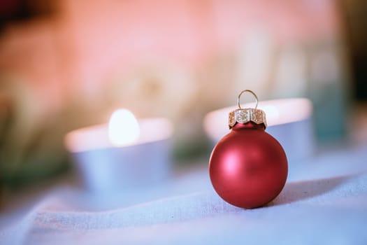 Christmas decoration: Close up of red Christmas baubles, advent calendar in the blurry background