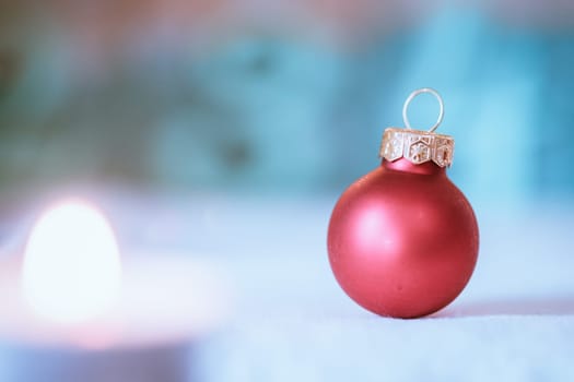 Christmas decoration: Close up of red Christmas baubles, advent calendar in the blurry background