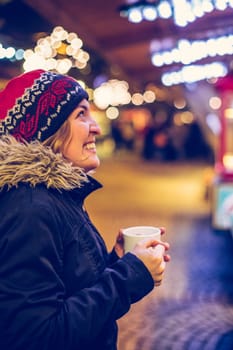 Girl is drinking mulled wine on the Christmas market, fun