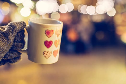 Enjoying Christmas time on the Christmas market. Close up of a cup of mulled wine.