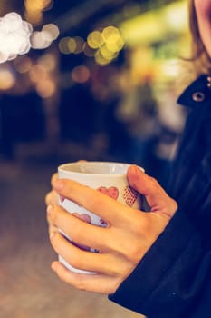 Enjoying Christmas time on the Christmas market. Close up of a cup of mulled wine.