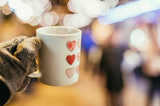 Enjoying Christmas time on the Christmas market. Close up of a cup of mulled wine.