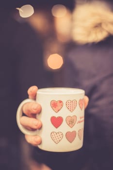Enjoying Christmas time on the Christmas market. Close up of a cup of mulled wine.