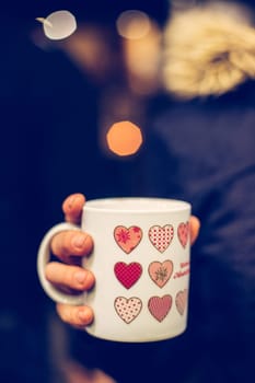 Enjoying Christmas time on the Christmas market. Close up of a cup of mulled wine.