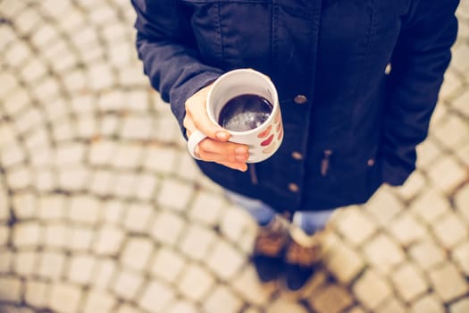 Enjoying Christmas time on the Christmas market. Close up of a cup of mulled wine.