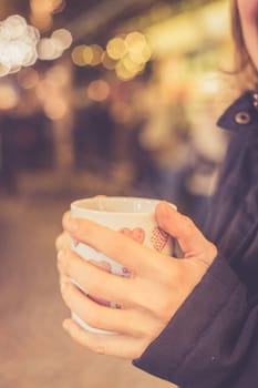 Enjoying Christmas time on the Christmas market. Close up of a cup of mulled wine.