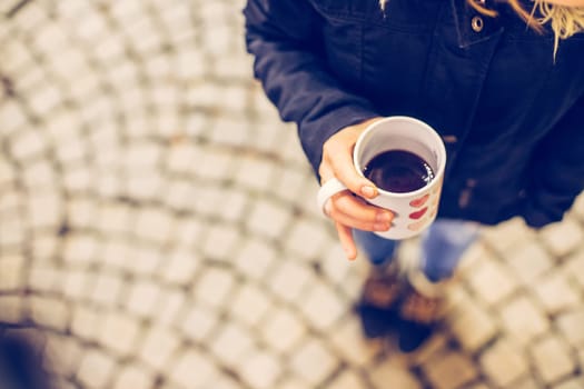 Enjoying Christmas time on the Christmas market. Close up of a cup of mulled wine.