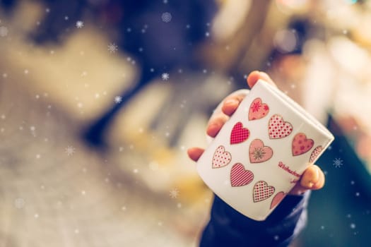 Enjoying Christmas time on the Christmas market. Close up of a cup of mulled wine.