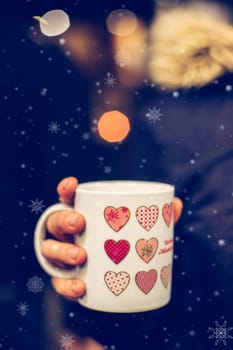 Enjoying Christmas time on the Christmas market. Close up of a cup of mulled wine.