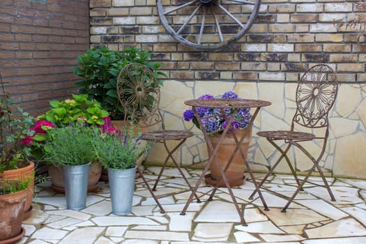 beautiful place in the garden in the mediterranean style, brick wall with grill and pots with flowers
