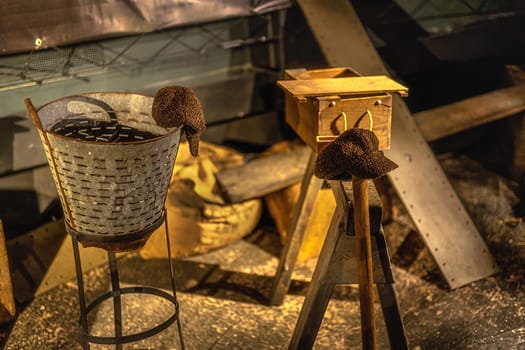 Selective focus on left workers caps and vintage equipment in abandoned factory, workshop or shipyard in Belfast, Northern Ireland