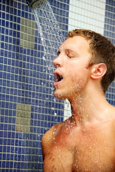 Portrait of handsome blond man under an outdoor shower