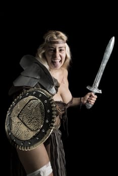 Ancient woman warrior or Gladiator posing in a dark background